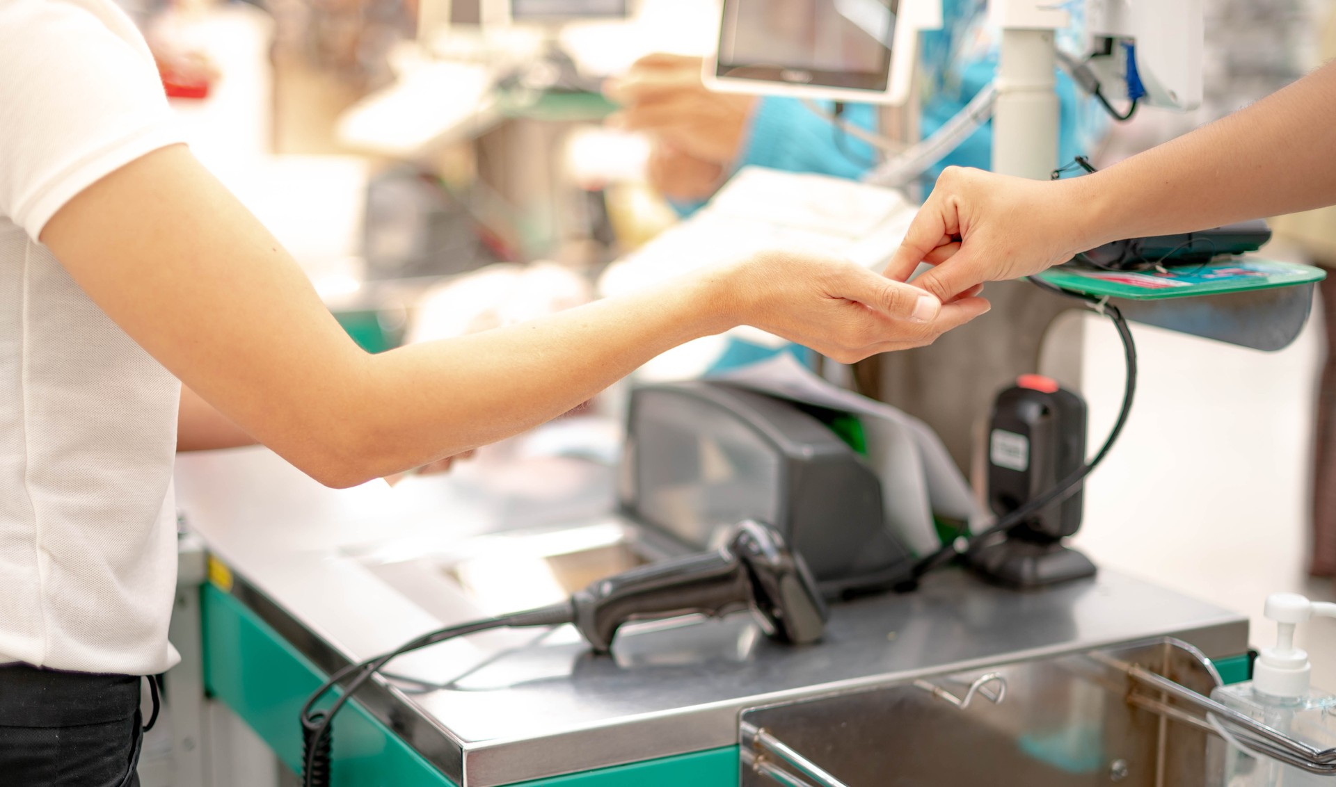 Female hand with coin money pay for goods concept. Hand giving cash and hand receiving cash, paying checkout at cashier access in supermarket.