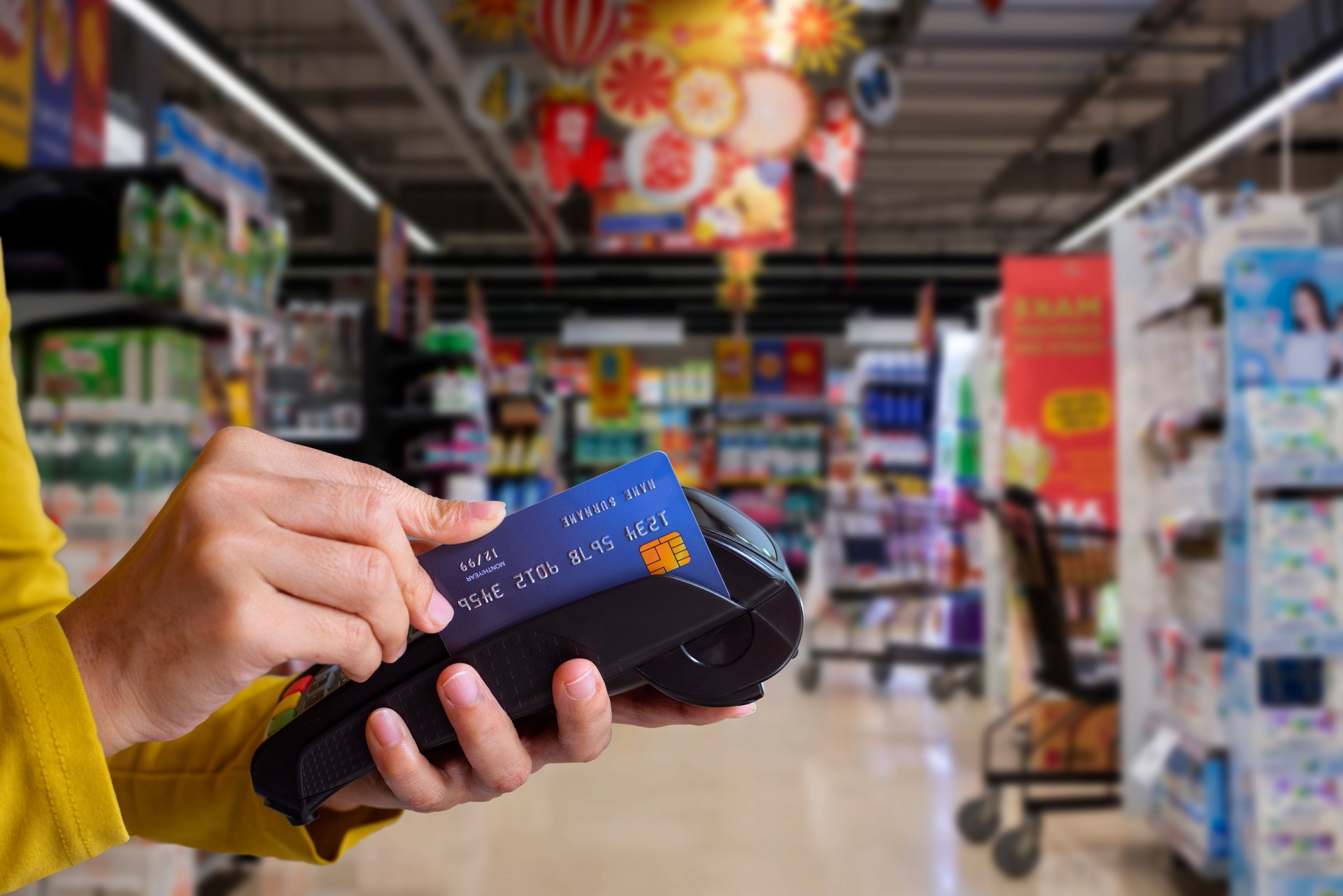 Paying with credit card in supermarket.